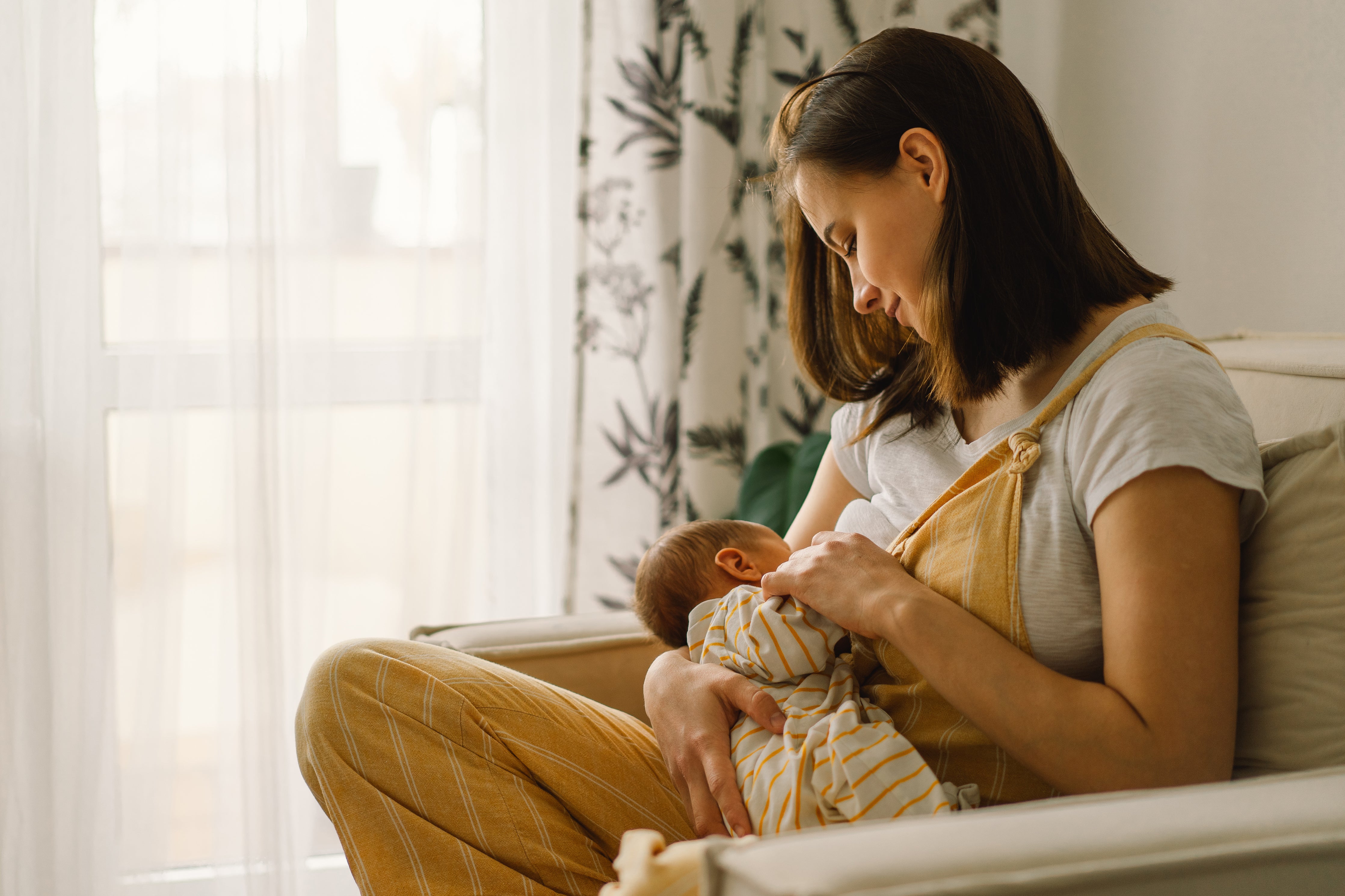 A mother wondering how much water should you drink when breastfeeding.